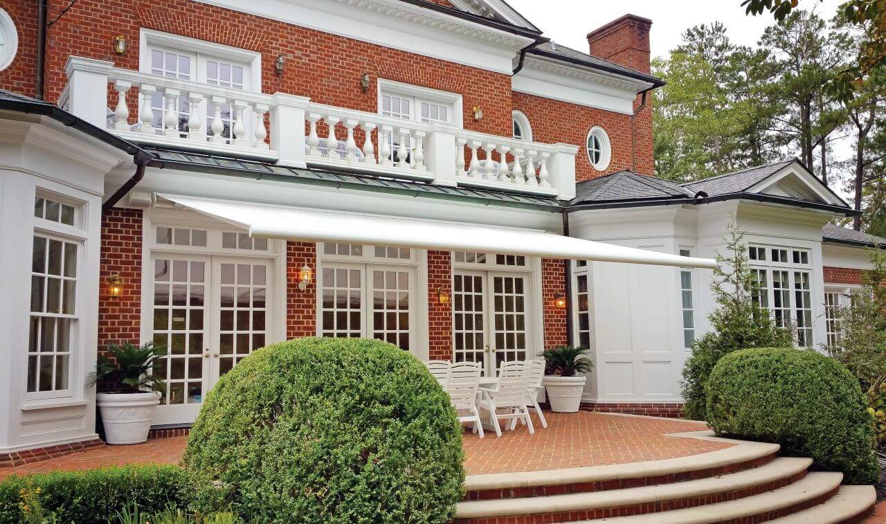 Motorized awning on the back porch of a house