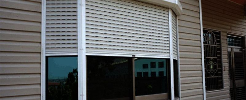 Security shutters coming down over a bay window