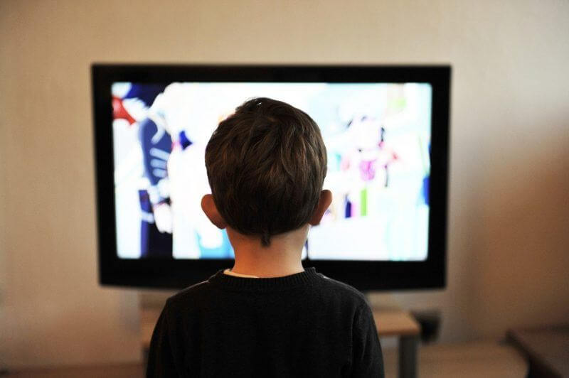 children in from of tv screen