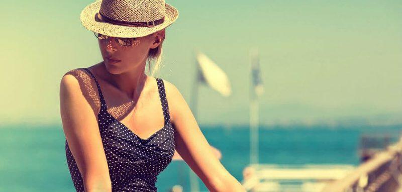 young woman sunbathing in blue swimsuit