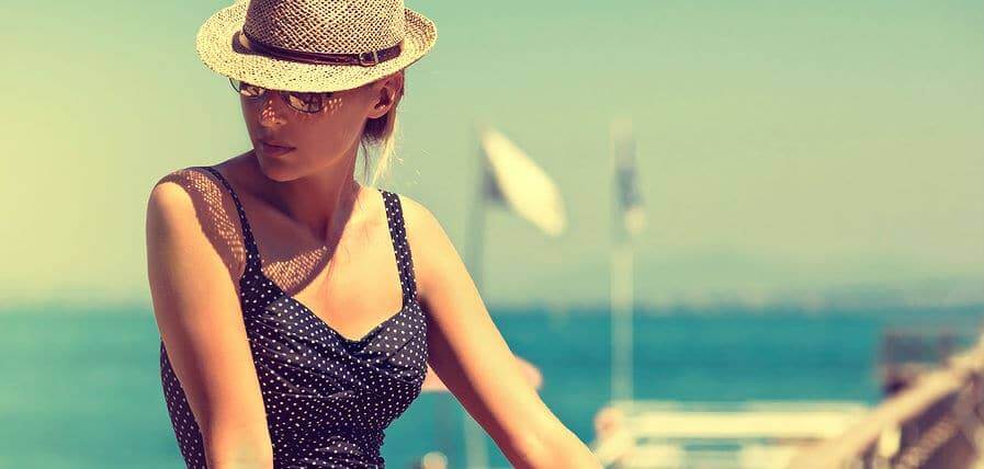 young woman sunbathing in blue swimsuit