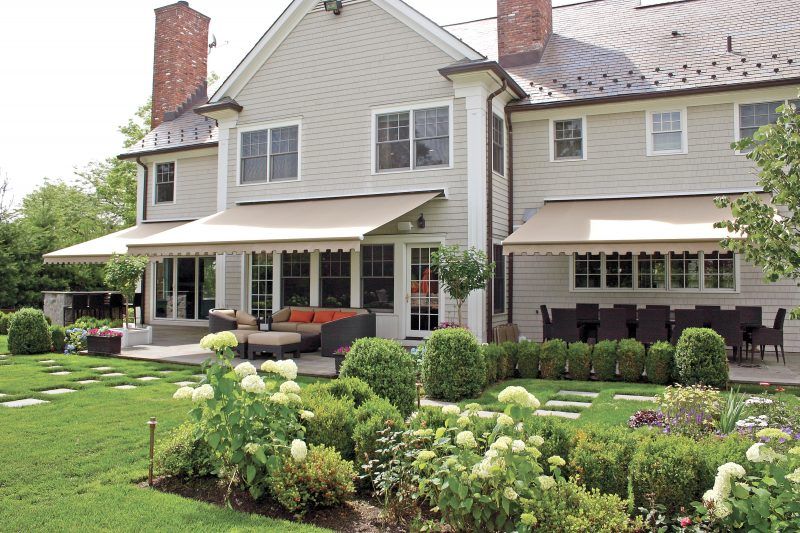 Home with three patio awnings